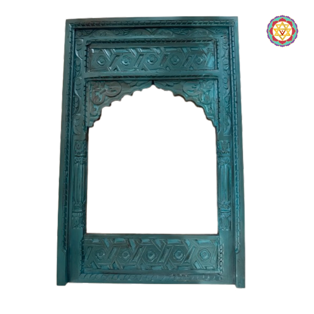 Close-up of detailed arch carving on a traditional wooden jharokha frame