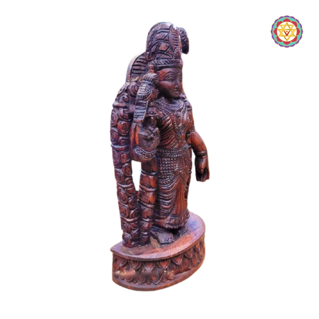 Woodcarved Meenakshi Amman statue in traditional South Indian temple style