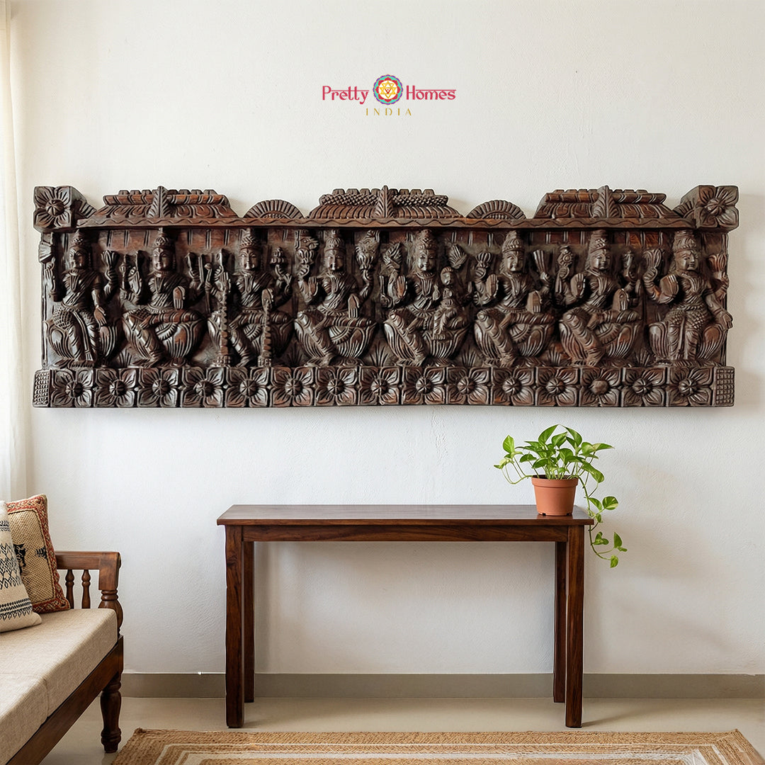 A horizontal hand-carved mahogany wood panel featuring the eight forms of Ashta Lakshmi.