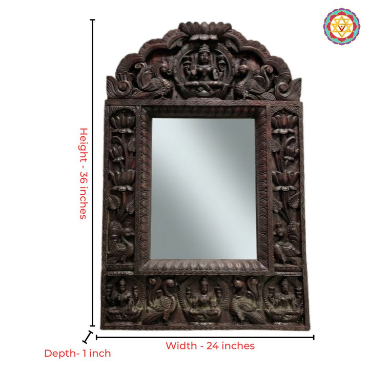 Intricate mahogany wood wall mirror frame showcasing Goddess Laxmi and graceful peacocks.