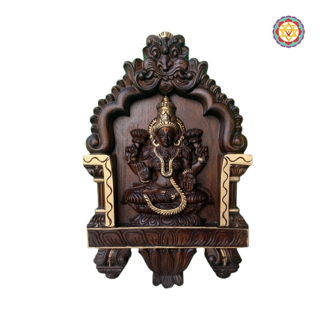 Intricate teak wood carving of Lakshmi with lotus motifs
