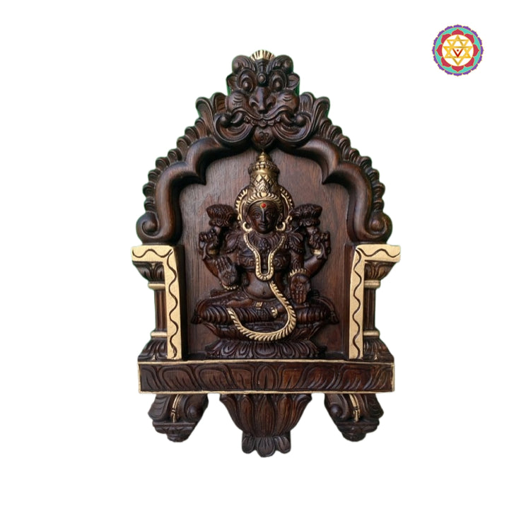 Intricate teak wood carving of Lakshmi with lotus motifs