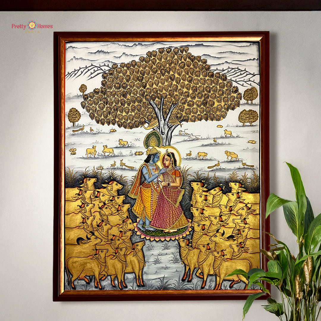 Hand painted paintings of Radha Krishna under a sacred tree.