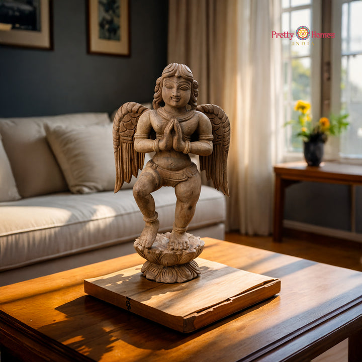 A vertical hand-carved solid teak Gandharva in a welcoming Anjali Mudra pose.