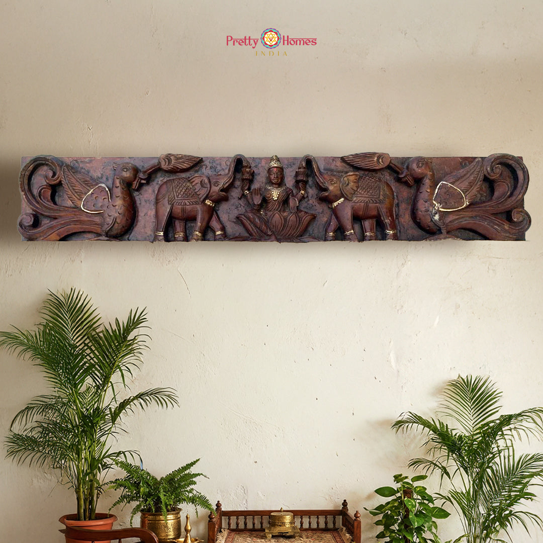 Hand-carved Gajalaxmi wood wall panel with antique gold finish