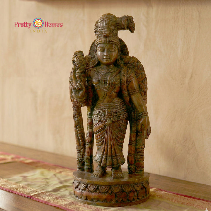 Woodcarved Meenakshi Amman statue in traditional South Indian temple style