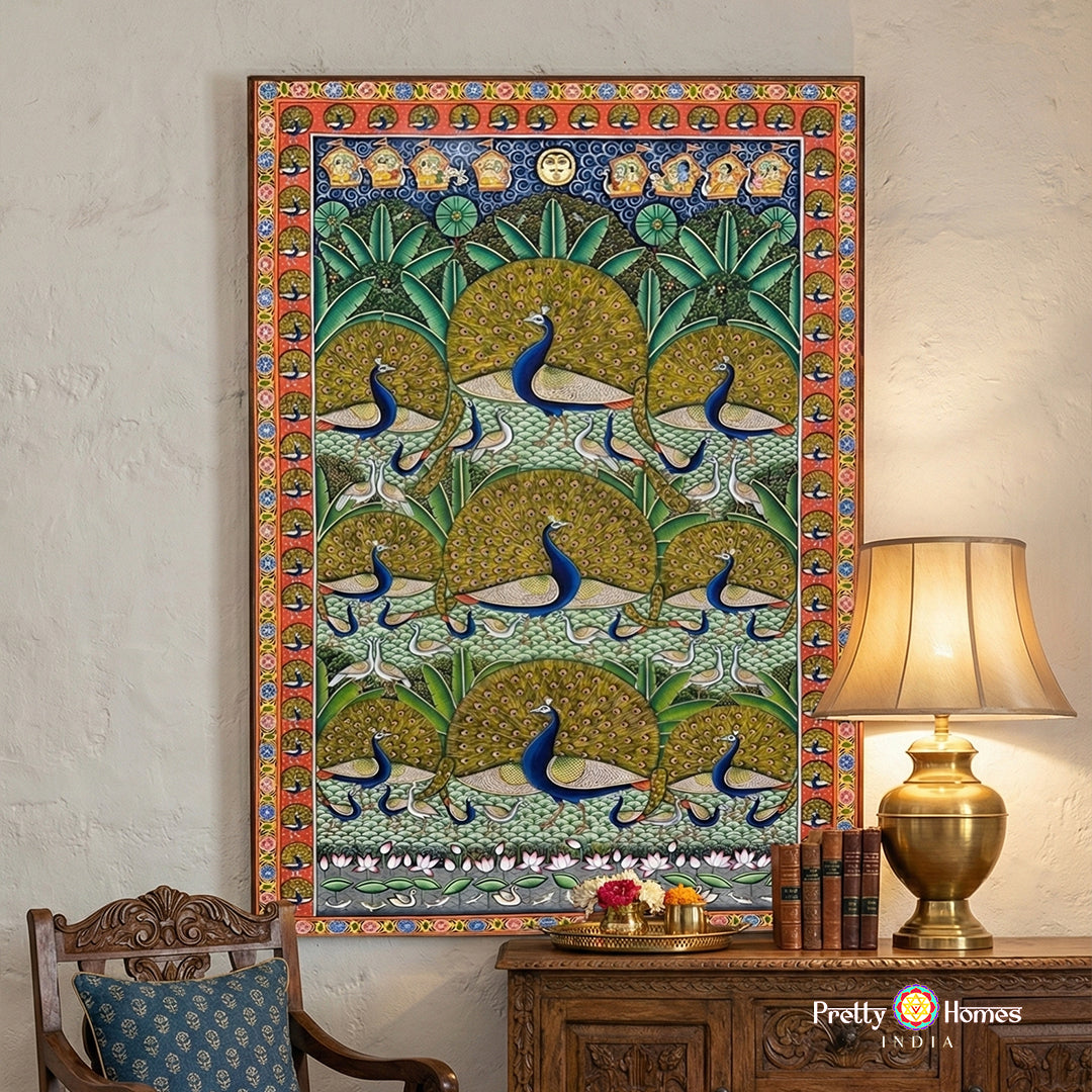 Hand-painted peacock pichwai artwork in a serene Morakuti forest setting