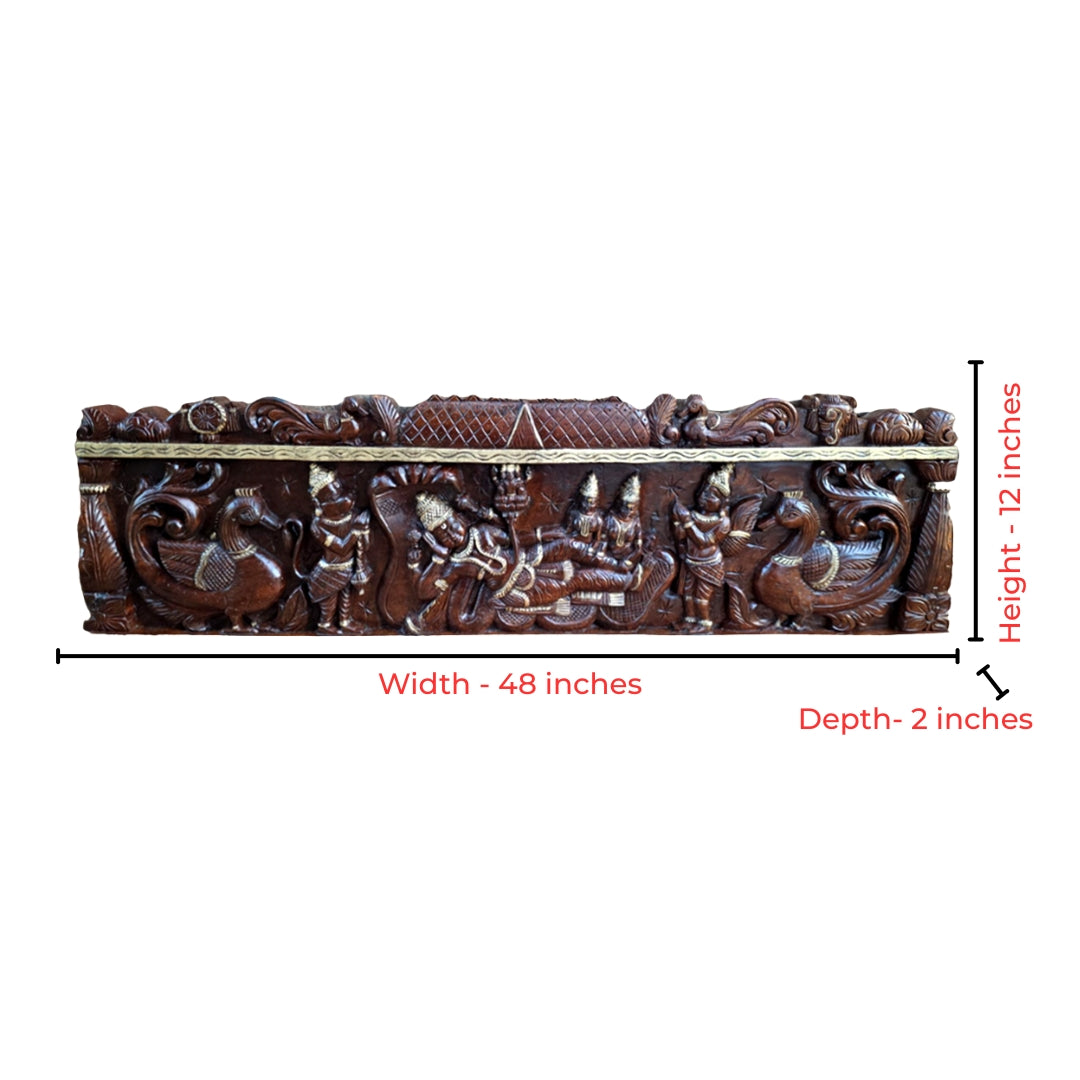 Intricate wood carving of Vishnu with Garuda and peacocks