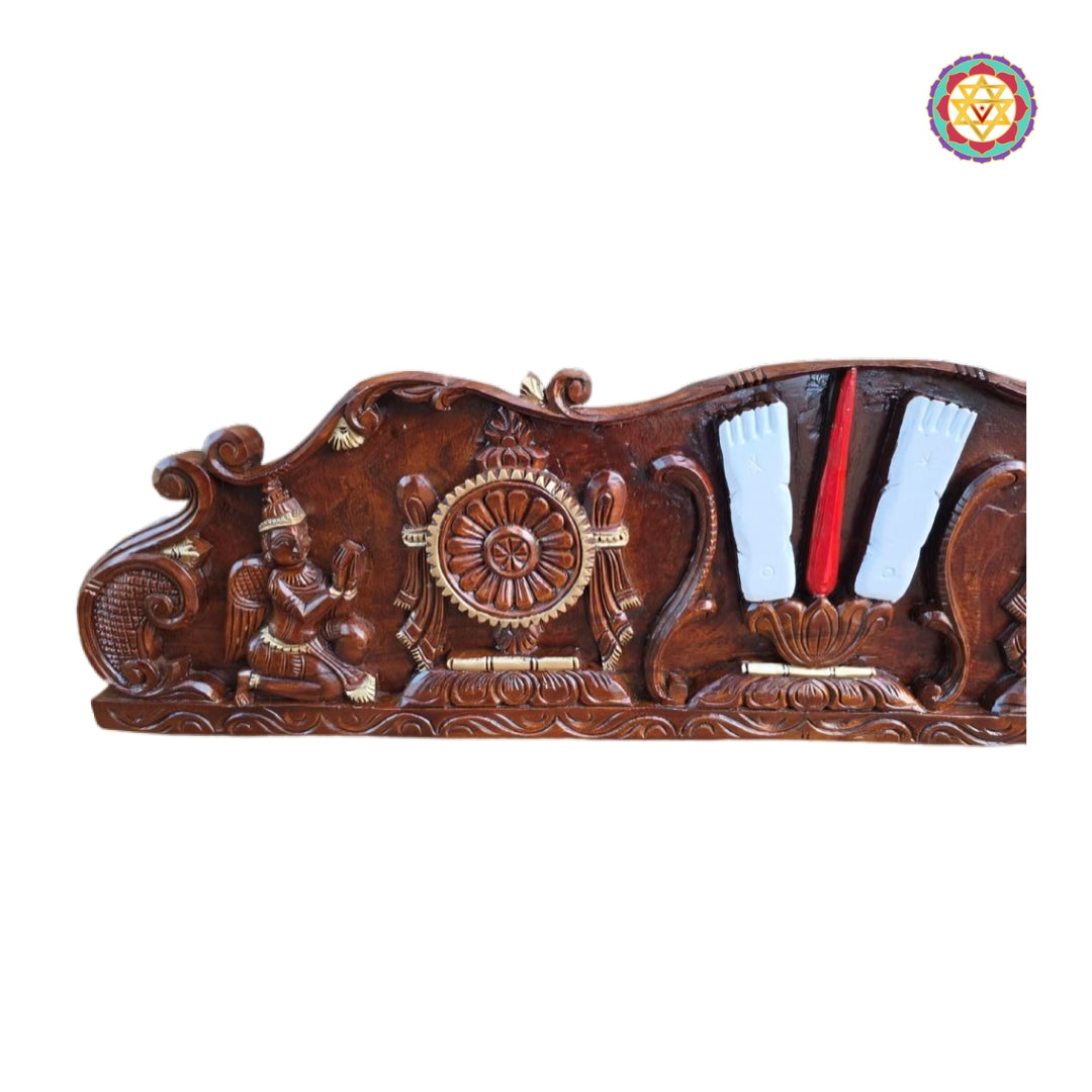 Close-up detailing of Shankh Chakra Namam symbols in carved wooden wall panel