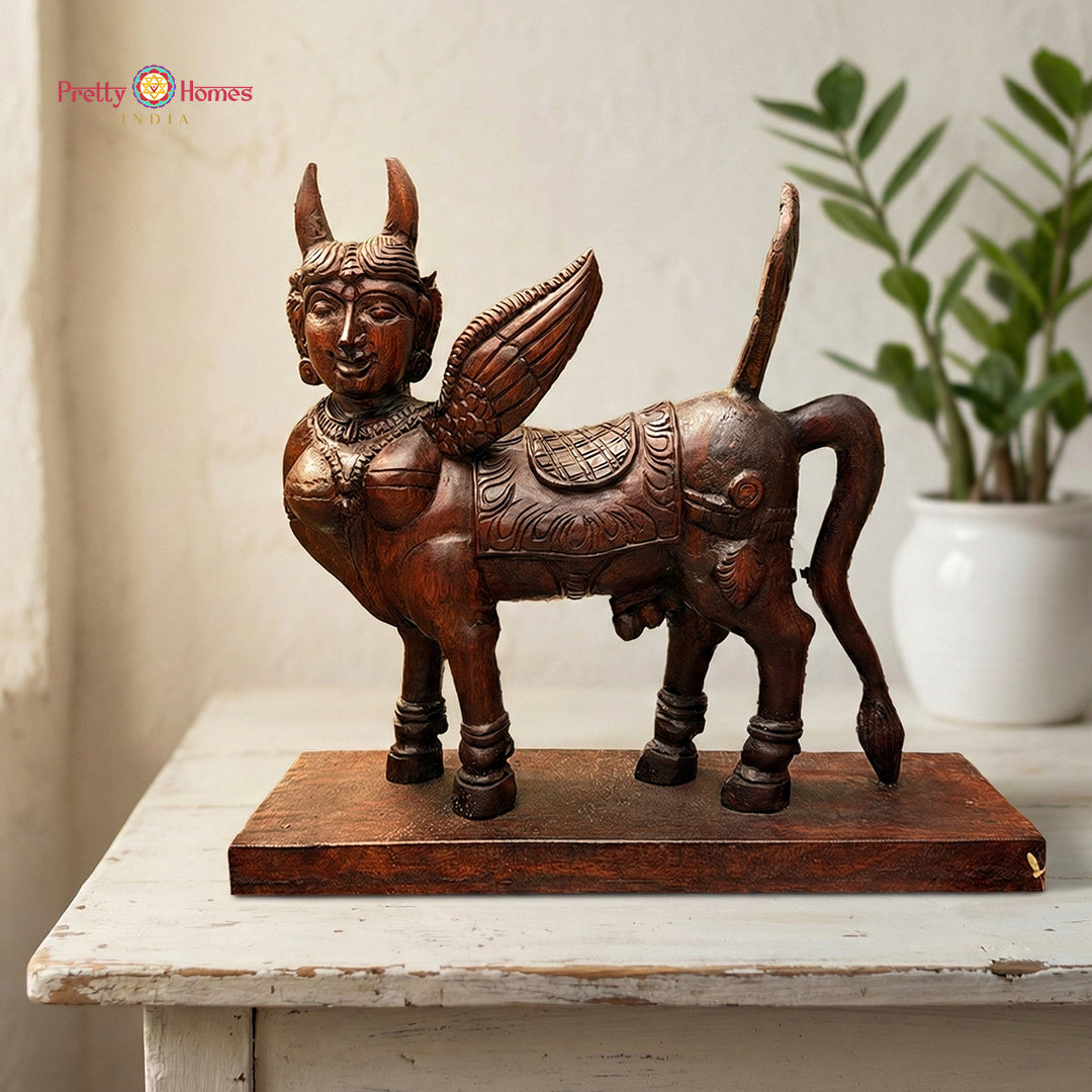 Woodcarved Kamadhenu sculpture symbolising abundance and prosperity