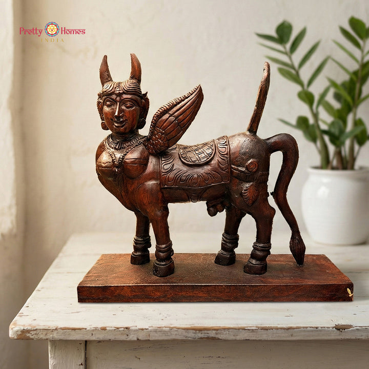 Woodcarved Kamadhenu sculpture symbolising abundance and prosperity