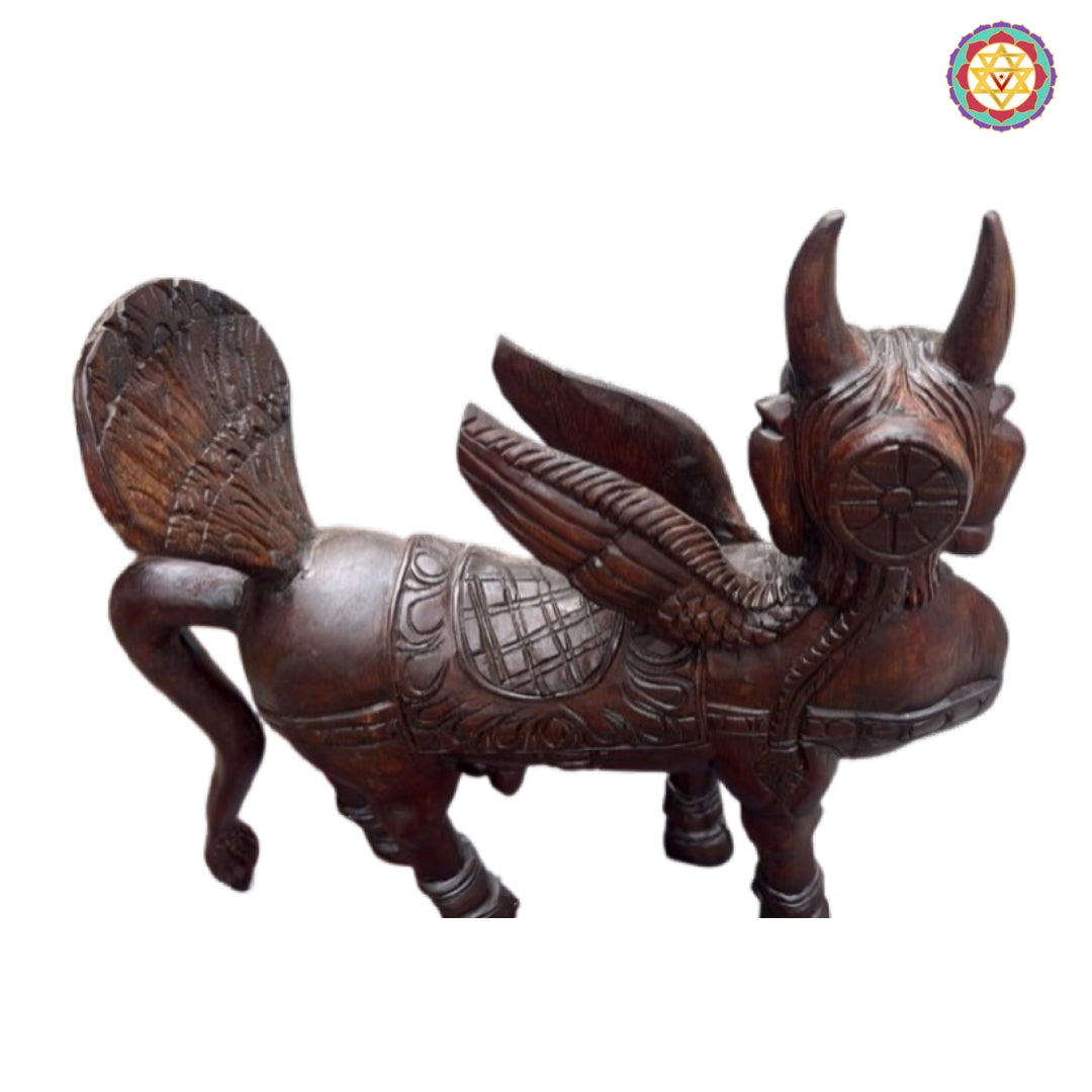 Close-up view of Kamadhenu wood carving with intricate sacred motifs